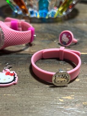 Hello Kitty watch set and Charm Set, comes with tin also . Never used